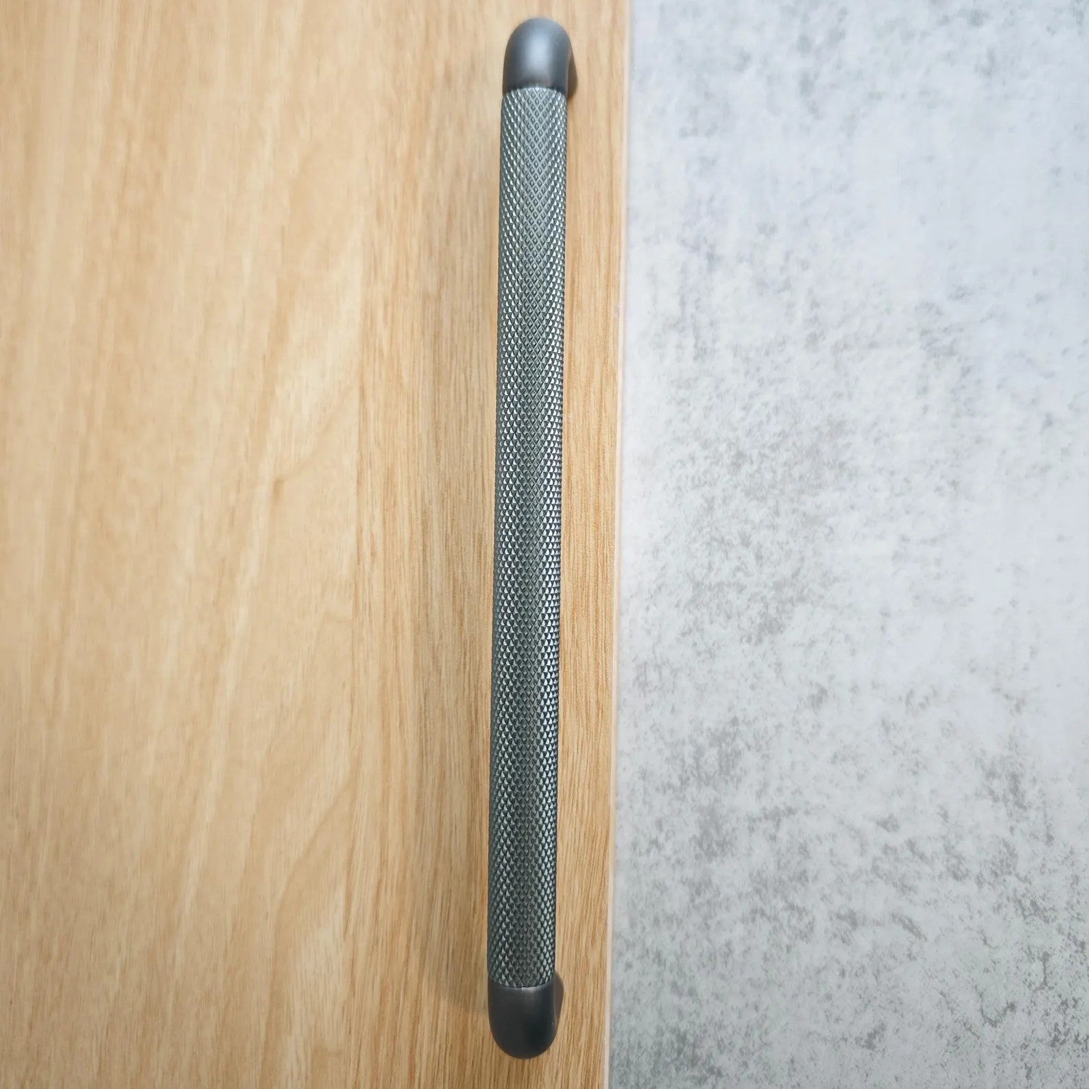 Brass Essence textured zinc alloy bar and knob handle set showing modern industrial design and detailed surface finish.
