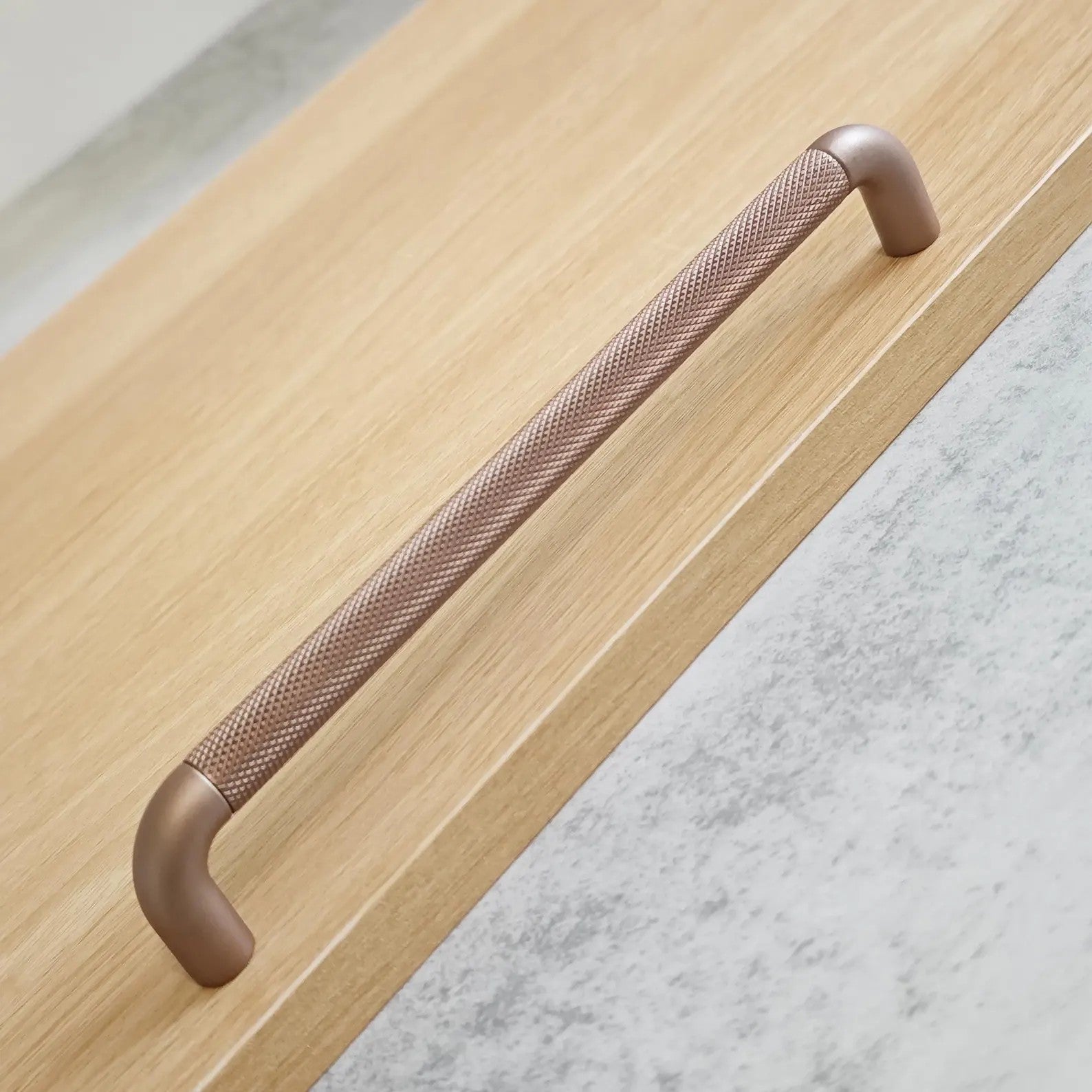 Textured zinc alloy bar and knob handle set in modern industrial style by Brass Essence, shown in a close-up image.