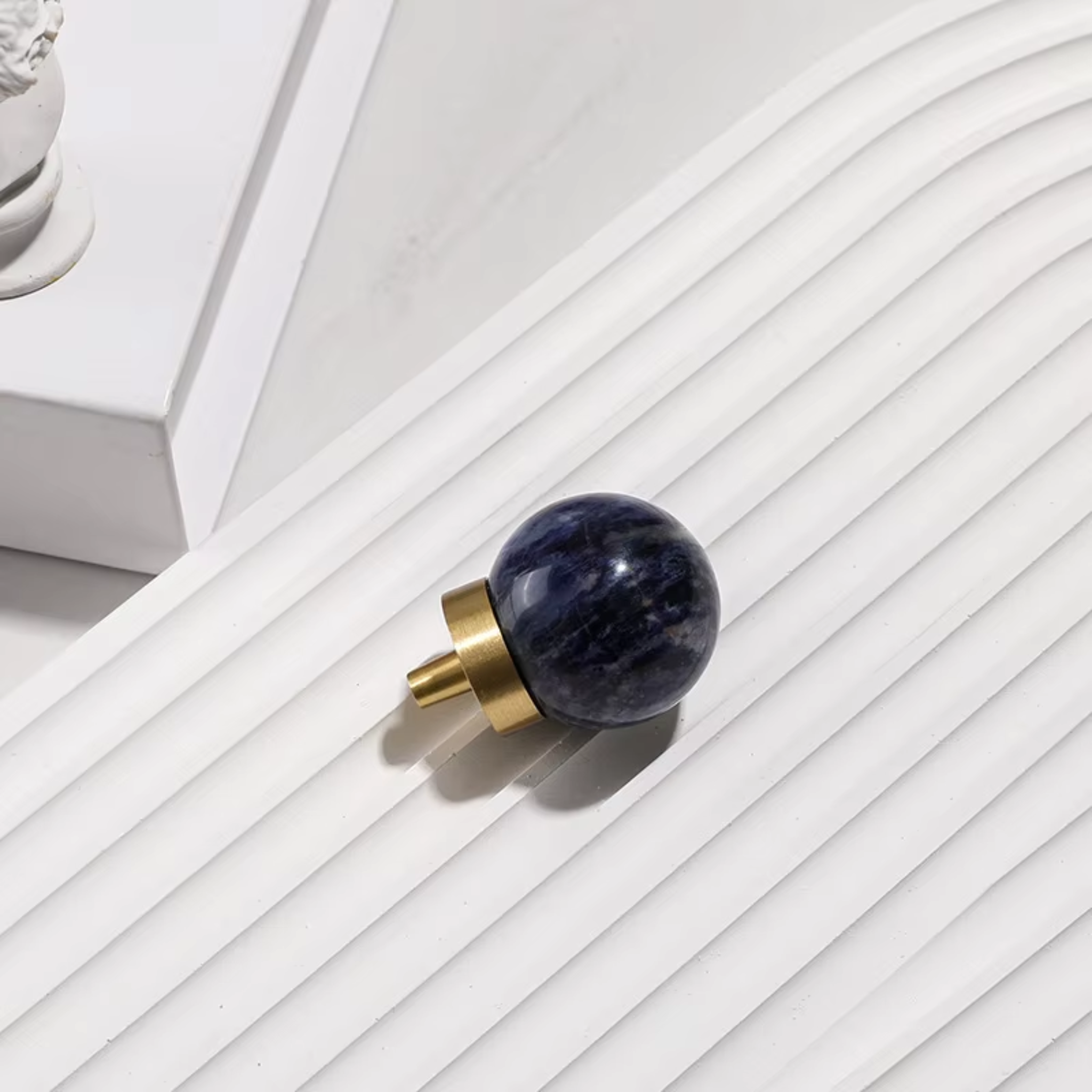 Natural crystal ball and brass cabinet knob by Brass Essence, showcasing a polished crystal sphere alongside a brass handle.