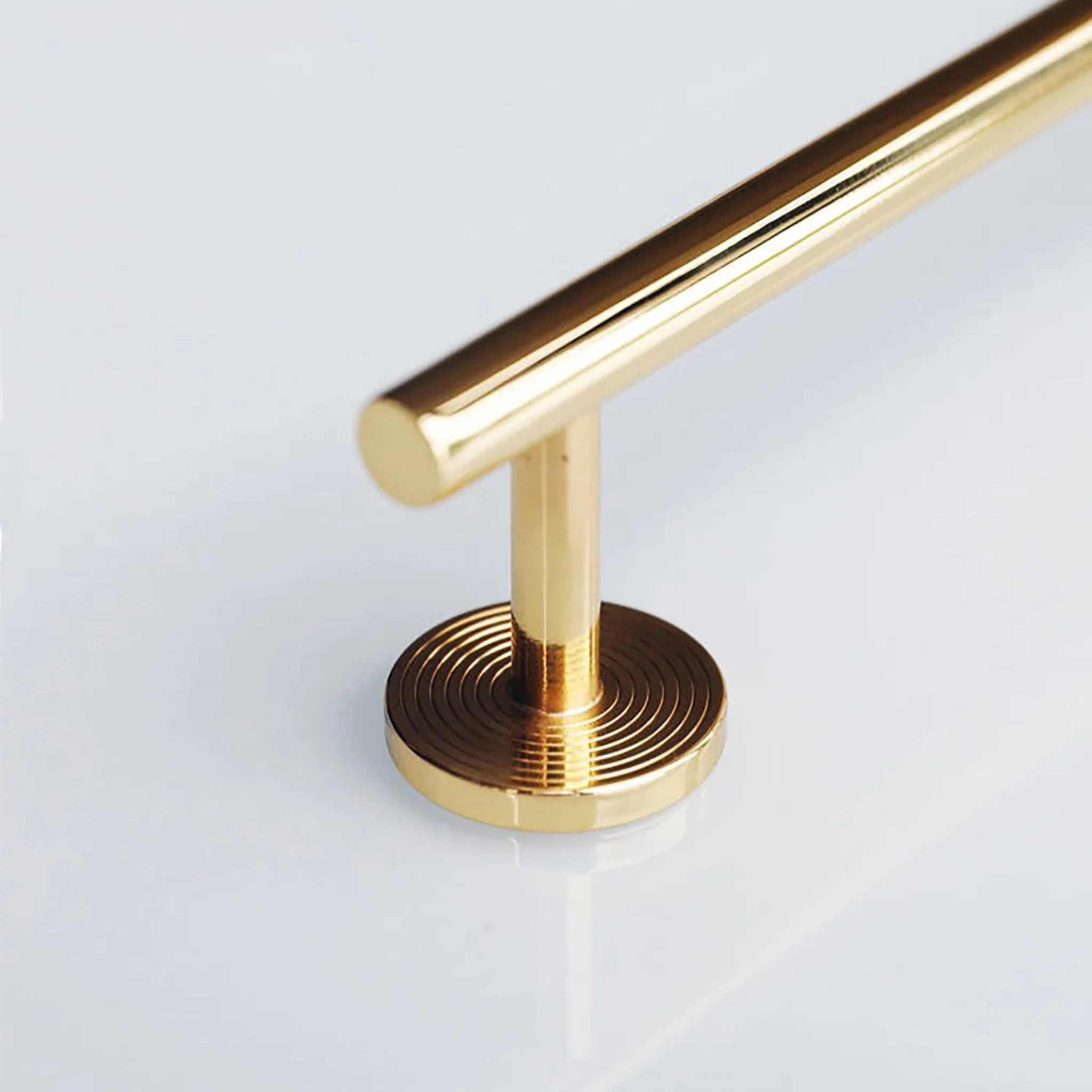 Minimalist Brass Concentric Ring Handles by Brass Essence, showing sleek gold-colored handles with concentric circle design.