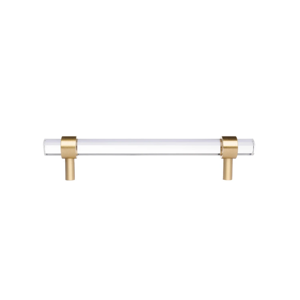 Clear acrylic and brass T-bar handle from Brass Essence collection, shown on a sleek cabinet or drawer surface.