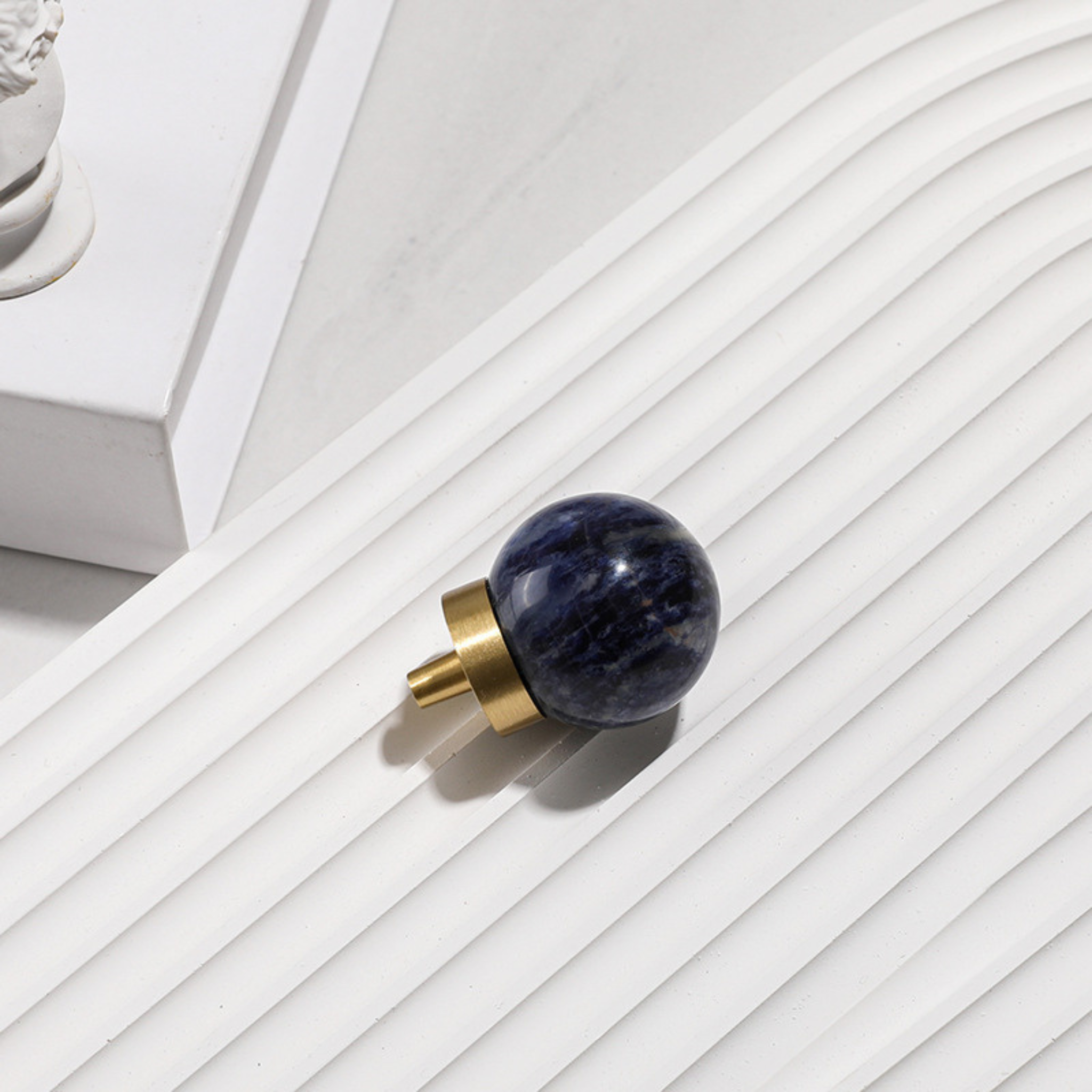 Natural crystal ball and brass cabinet knob from Brass Essence, showcasing a polished crystal sphere with a brass mounting.