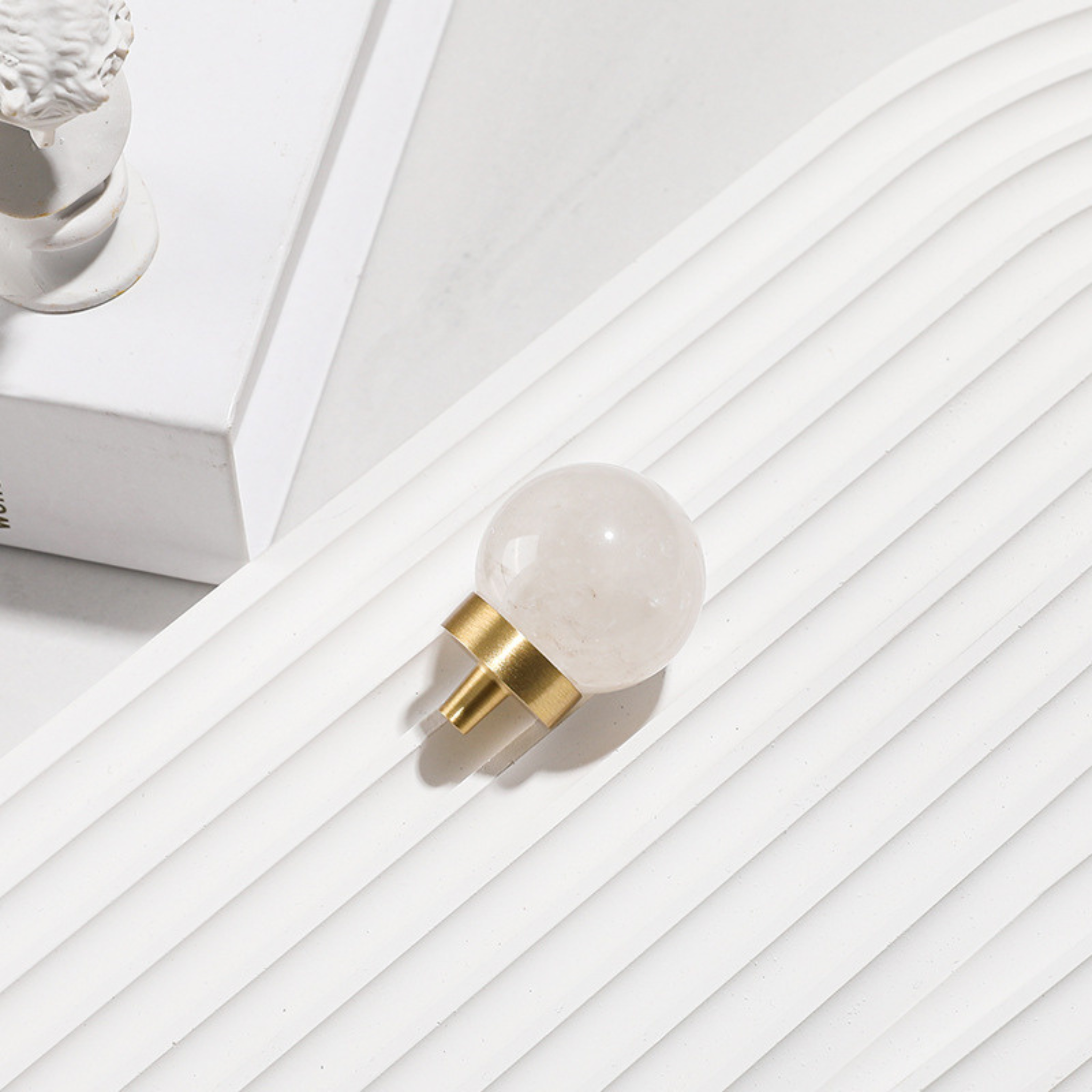 Natural crystal ball and brass cabinet knob by Brass Essence, showcasing the elegant crystal sphere and polished brass finish.