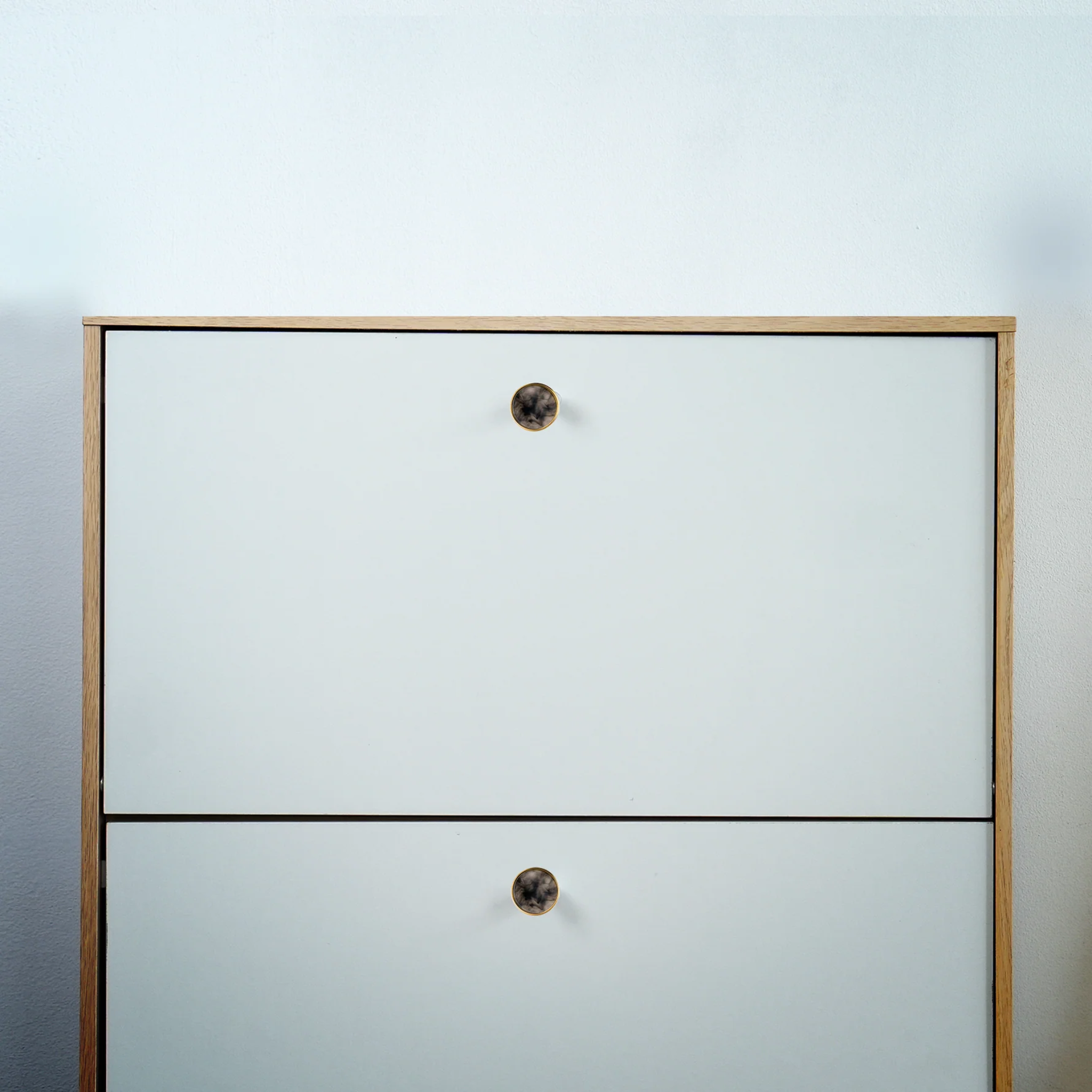 Brass Essence acrylic and brass disc cabinet knob with sleek round design, polished brass finish, and modern aesthetic.