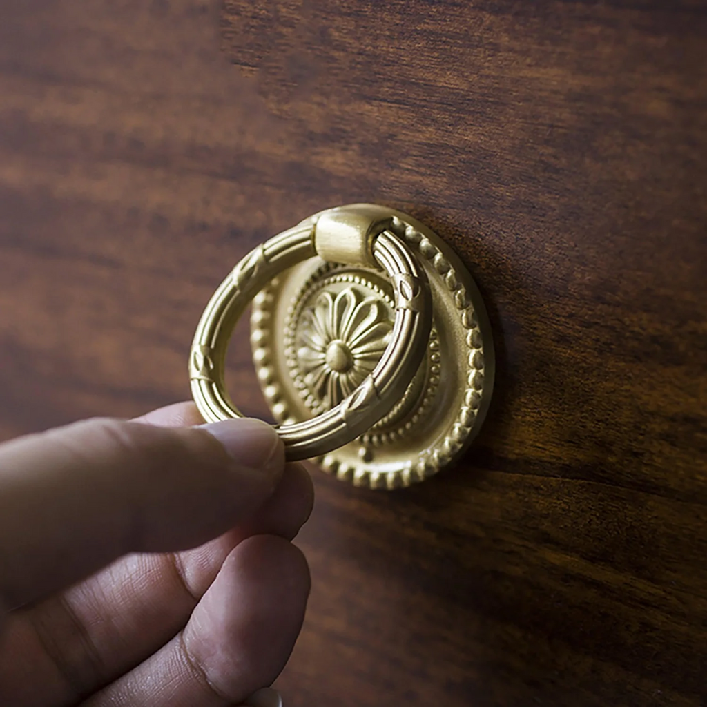 Vintage retro brass ring pull handle by Brass Essence, showing a round brass pull with a sturdy ring design for furniture drawers.