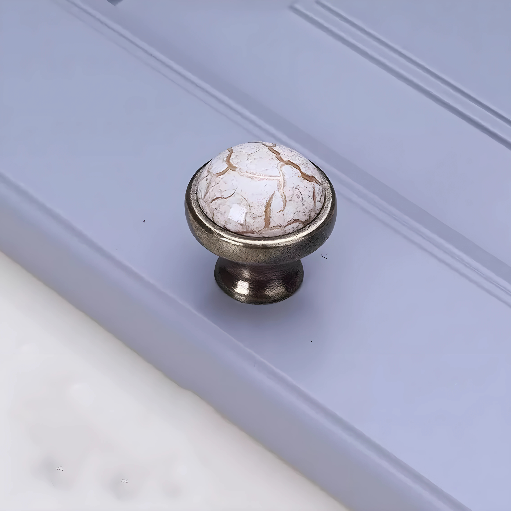 Antique ceramic and zinc cabinet handle from Brass Essence, showcasing a vintage design with decorative ceramic top and metal base.