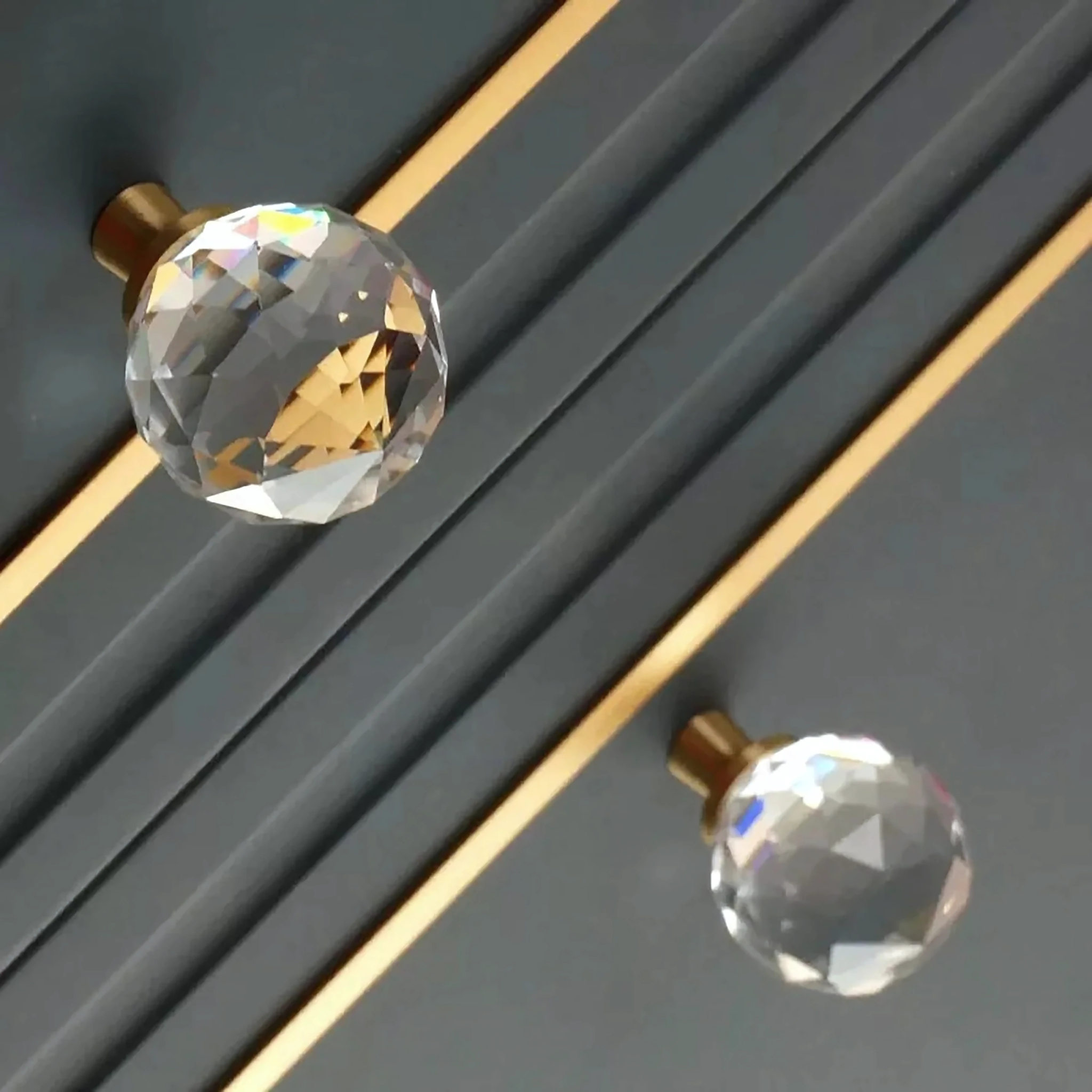 Faceted crystal and brass cabinet knob by Brass Essence, featuring a sparkling crystal design with a brass base and elegant detailing.