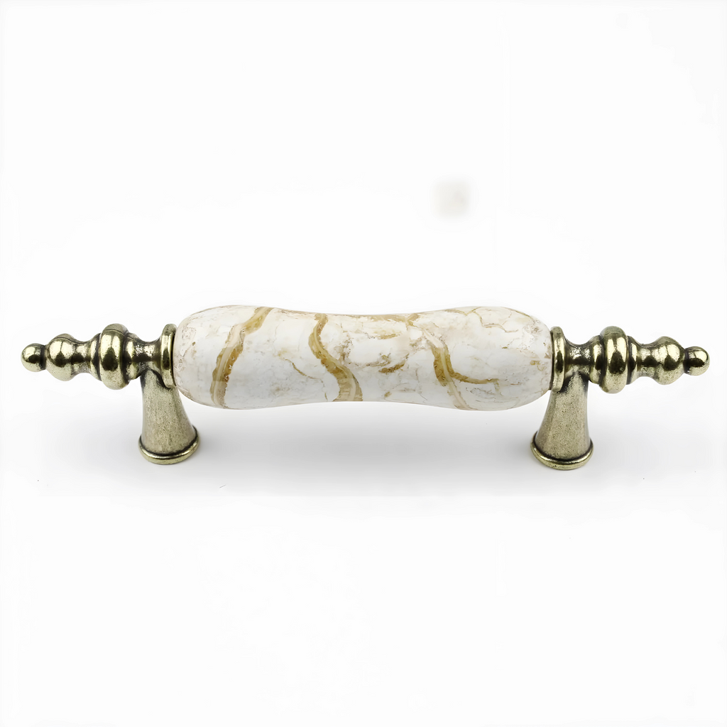Antique ceramic and zinc cabinet pulls by Brass Essence, featuring detailed ceramic handles with zinc backing, perfect for vintage furniture.