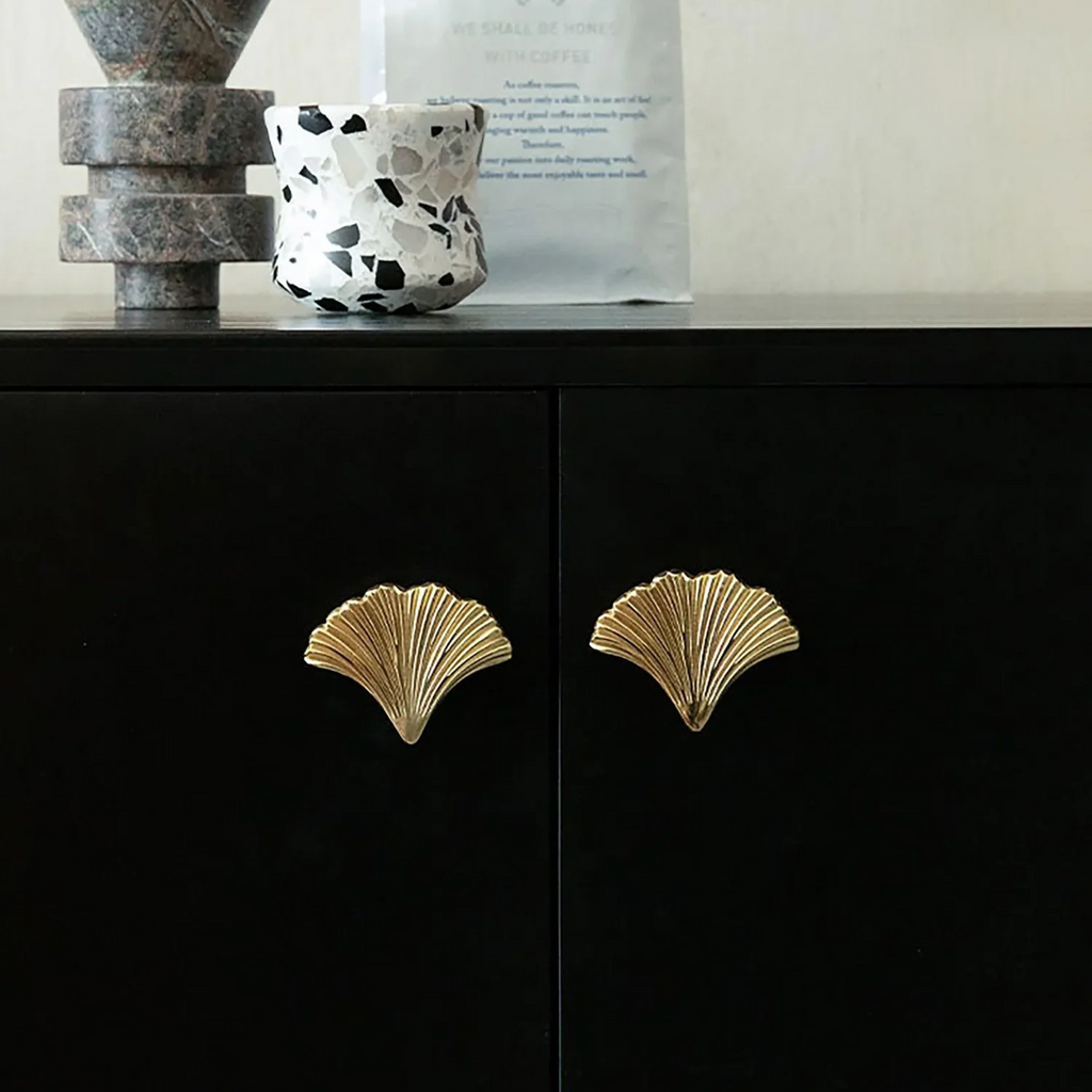 Polished gold Ginkgo leaf cabinet pull by Brass Essence, featuring detailed leaf design and smooth finish for furniture accents.