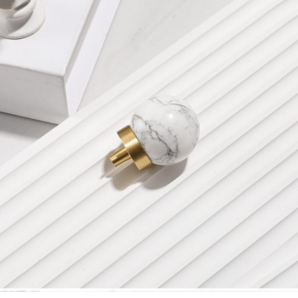 Natural crystal ball with brass cabinet knob by Brass Essence, showcasing the elegant glass sphere and polished brass hardware.