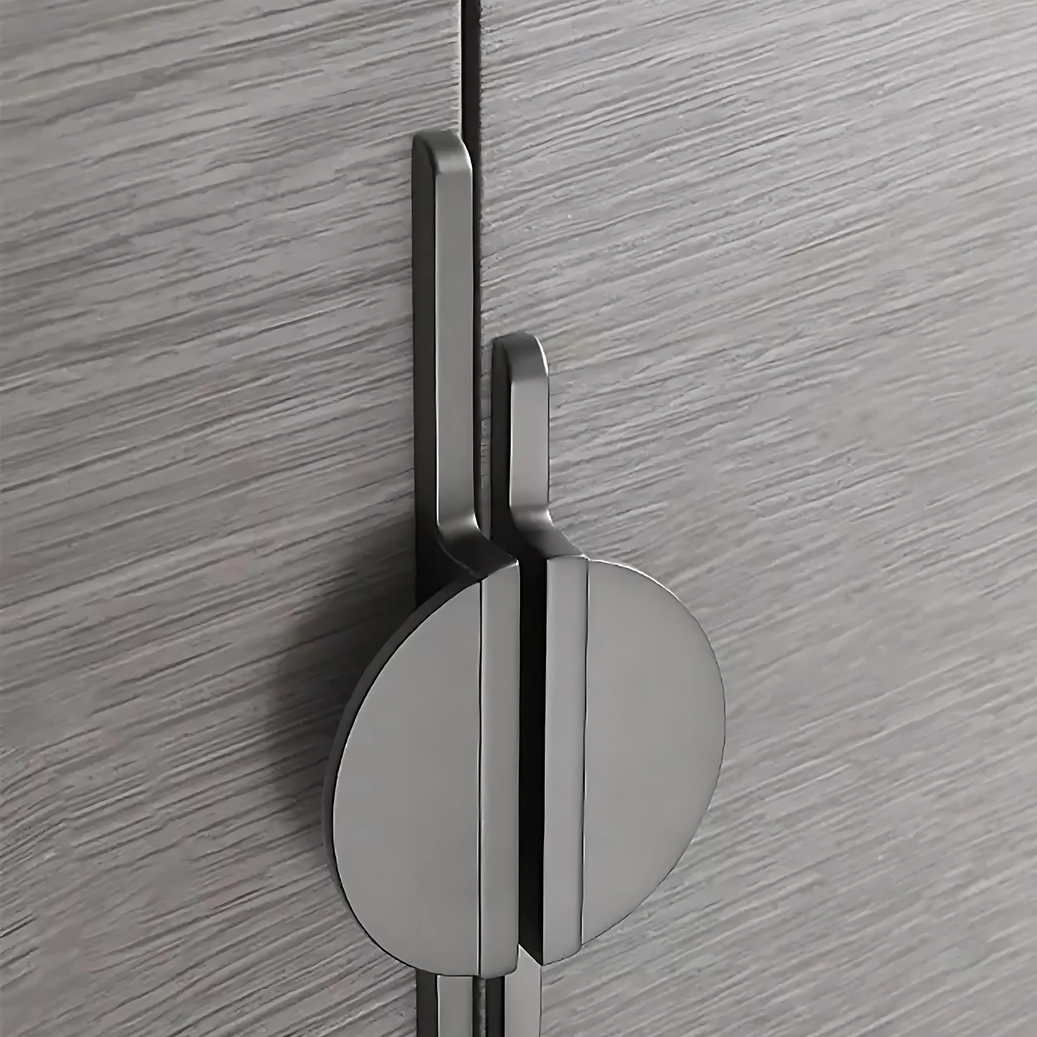 Modern circle and bar door handle by Brass Essence in gold and black zinc alloy with a premium finish, shown on a door.