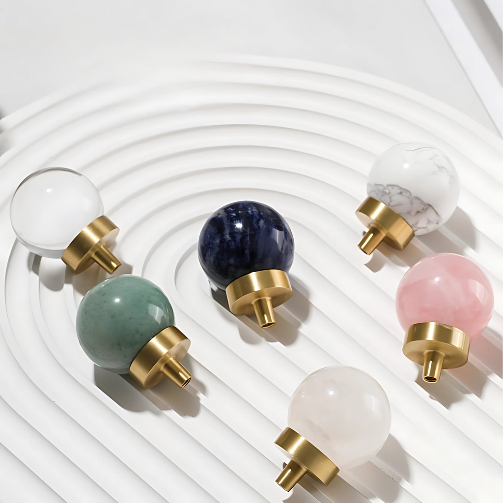 Natural crystal ball and brass cabinet knob by Brass Essence, showcasing a polished crystal sphere and vintage brass hardware.