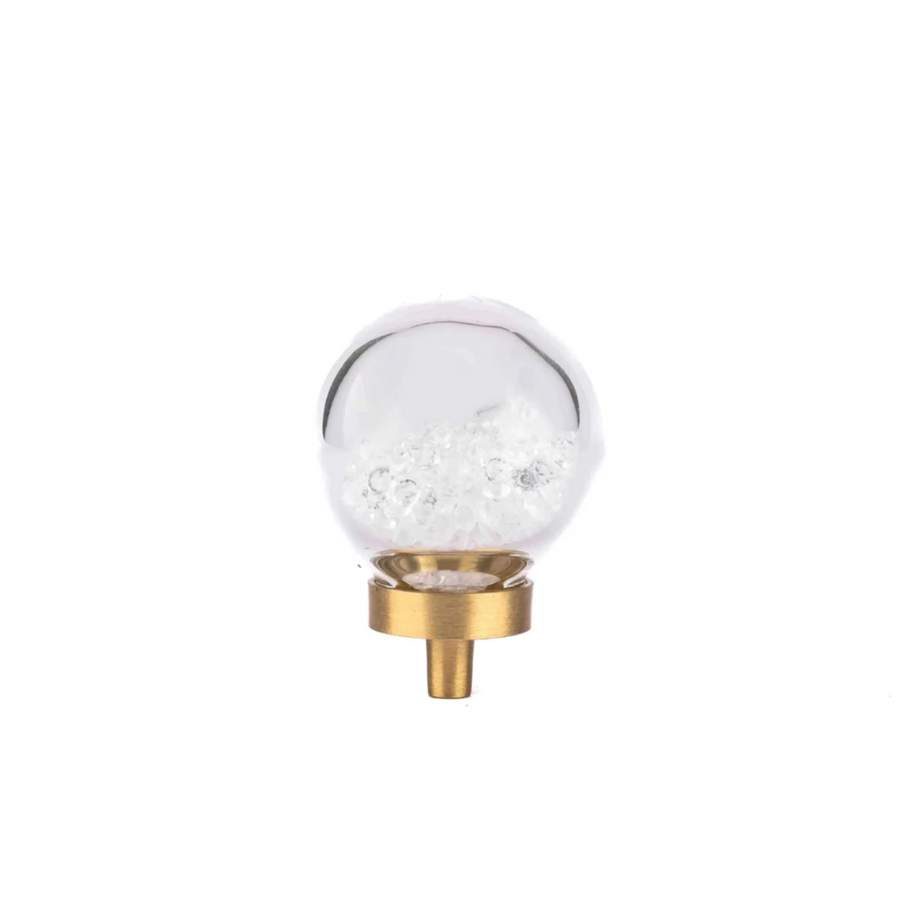 Brass essence Moon Orb glitter glass and brass knob with a moon design, shiny surface and ornate detailing.