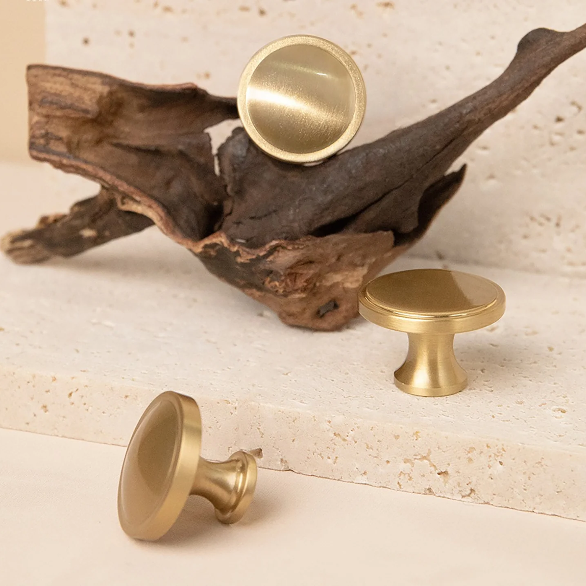Brass essence Krisha brushed brass round knob with smooth finish, suitable for furniture or cabinets, close-up view.