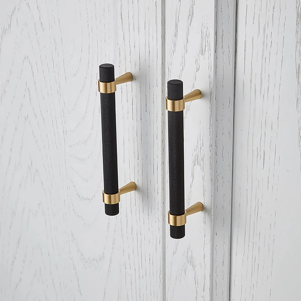 Brass Essence knurled black and gold T-bar handle collection, close-up of two T-bar handles with textured grip and polished finish.