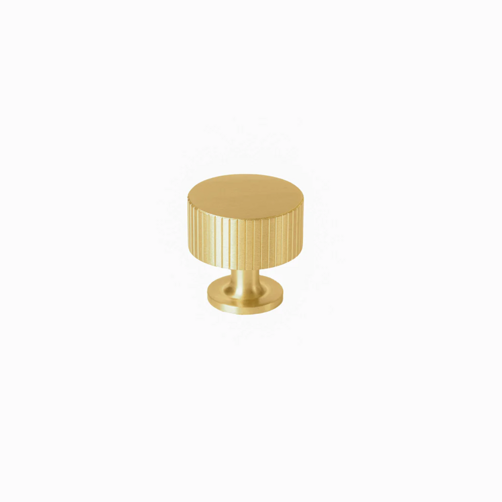 Brass essence linear knurled brass cabinet knob with textured surface, cylindrical shape, and polished finish.