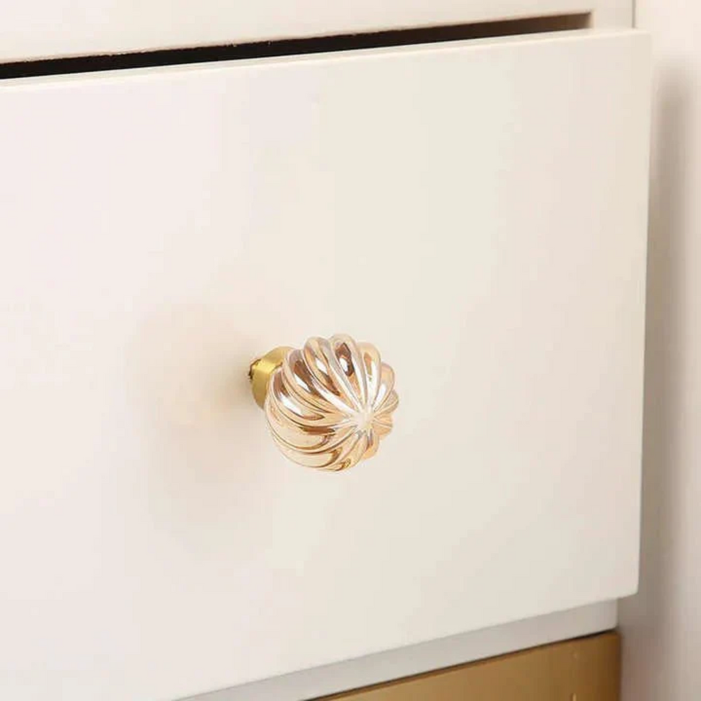 Brass Essence crystal drawer pulls with fluted and smooth designs, featuring elegant crystal accents for cabinet or drawer decoration.