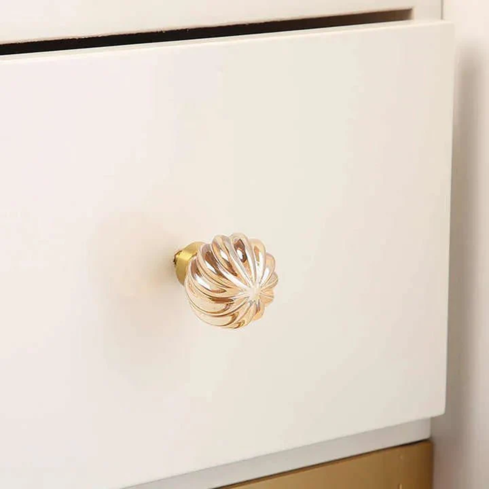 Brass Essence crystal drawer pulls with fluted and smooth designs, featuring elegant crystal accents for cabinet or drawer decoration.