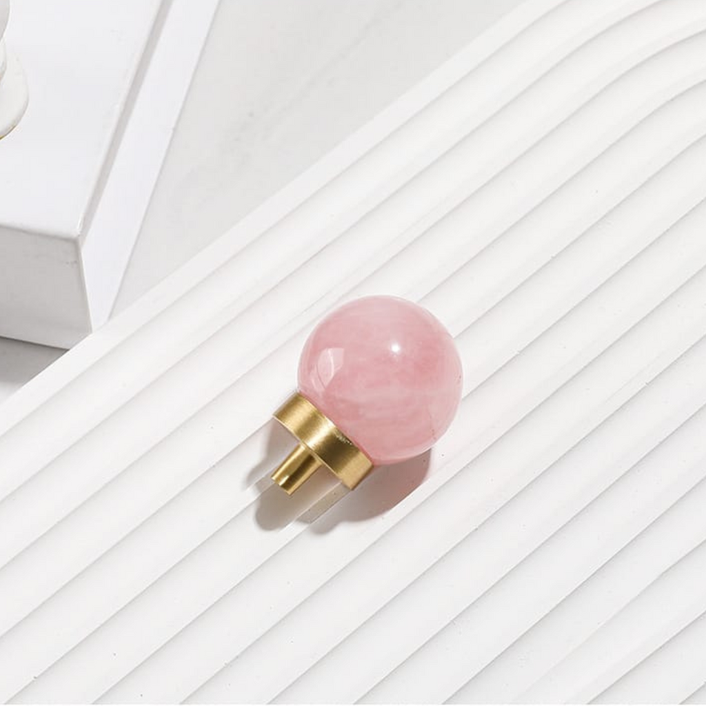 Natural crystal ball and brass cabinet knob by Brass Essence, showcasing a clear crystal sphere with brass mounting hardware.