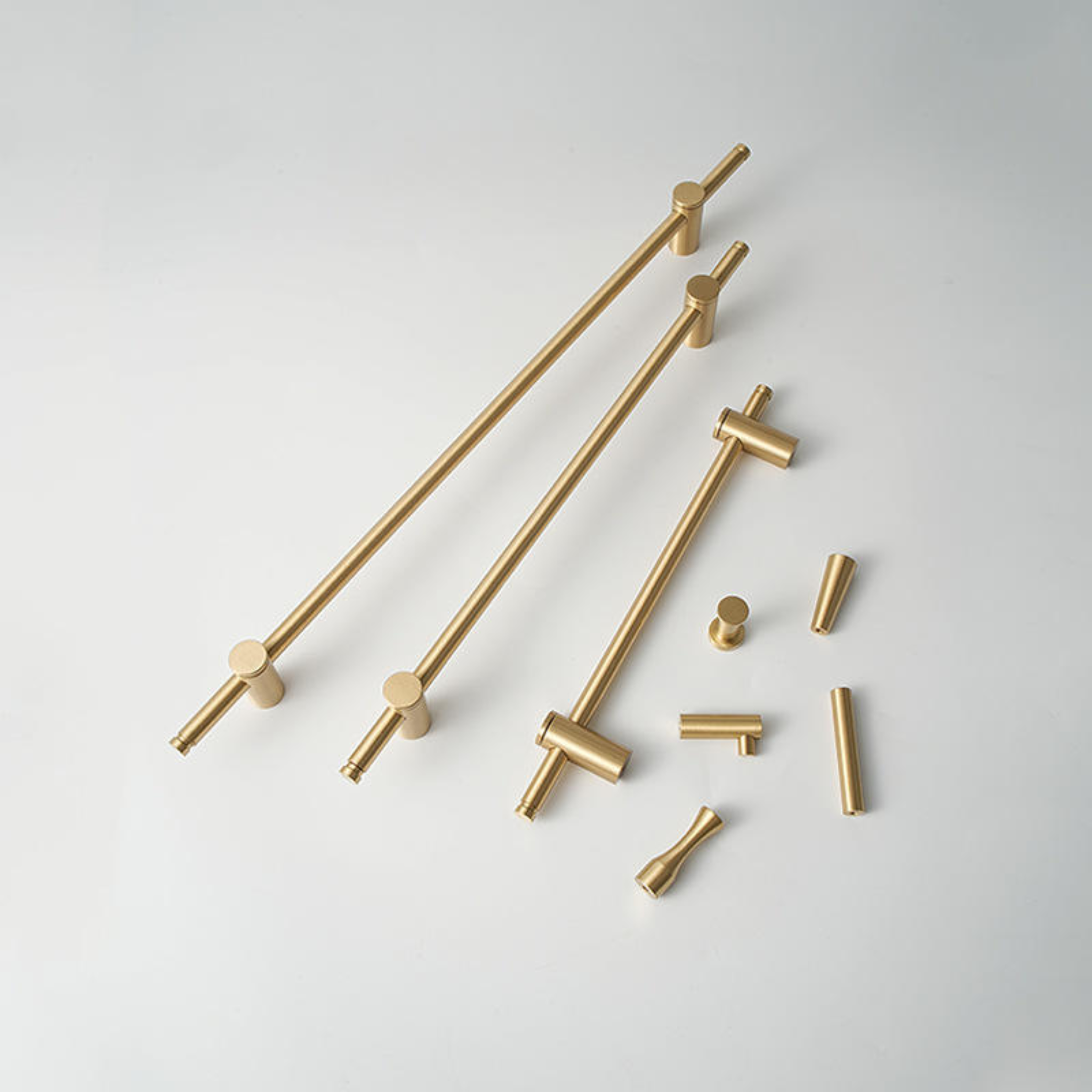 Adjustable solid brass bar handle from Brass Essence collection, showing a sleek, polished brass finish and sturdy construction.