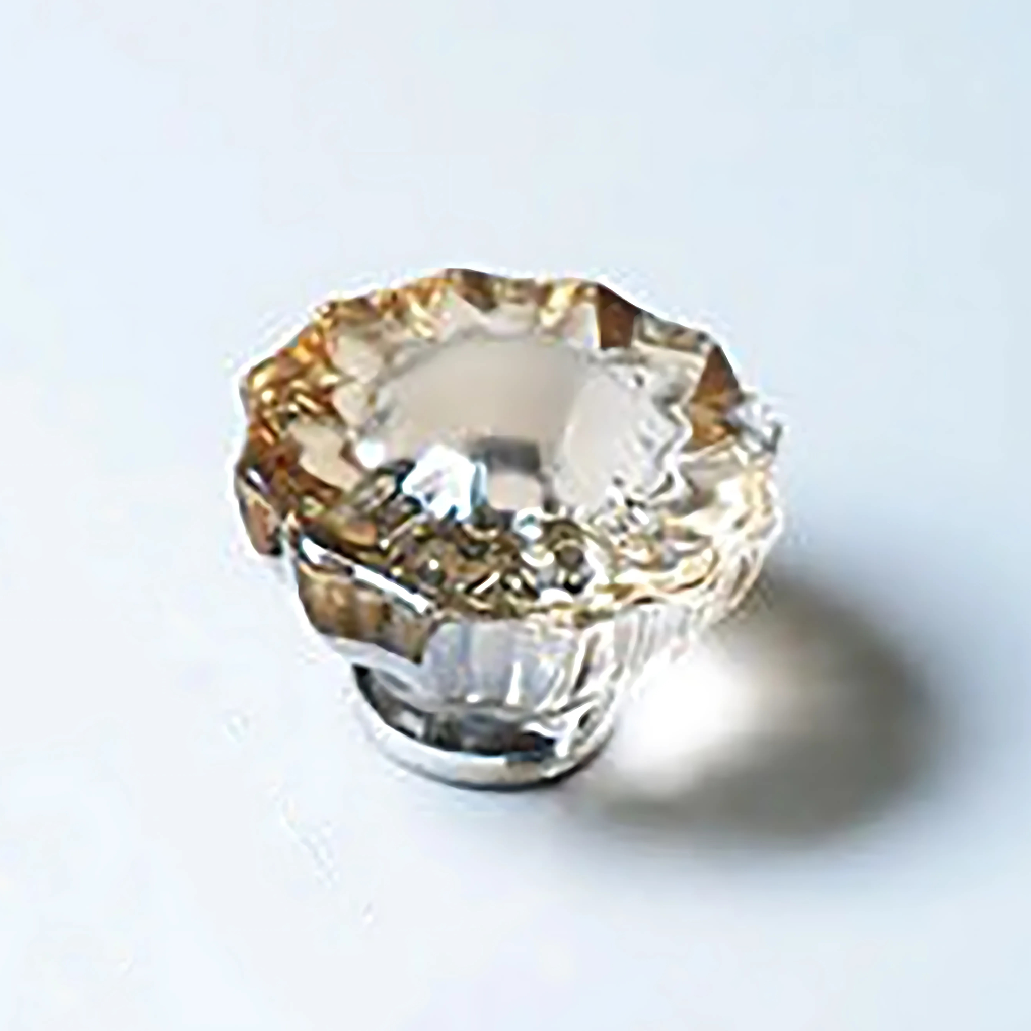 Faceted crystal and brass cabinet knob by Brass Essence, showcasing a sparkling crystal with polished brass finish.