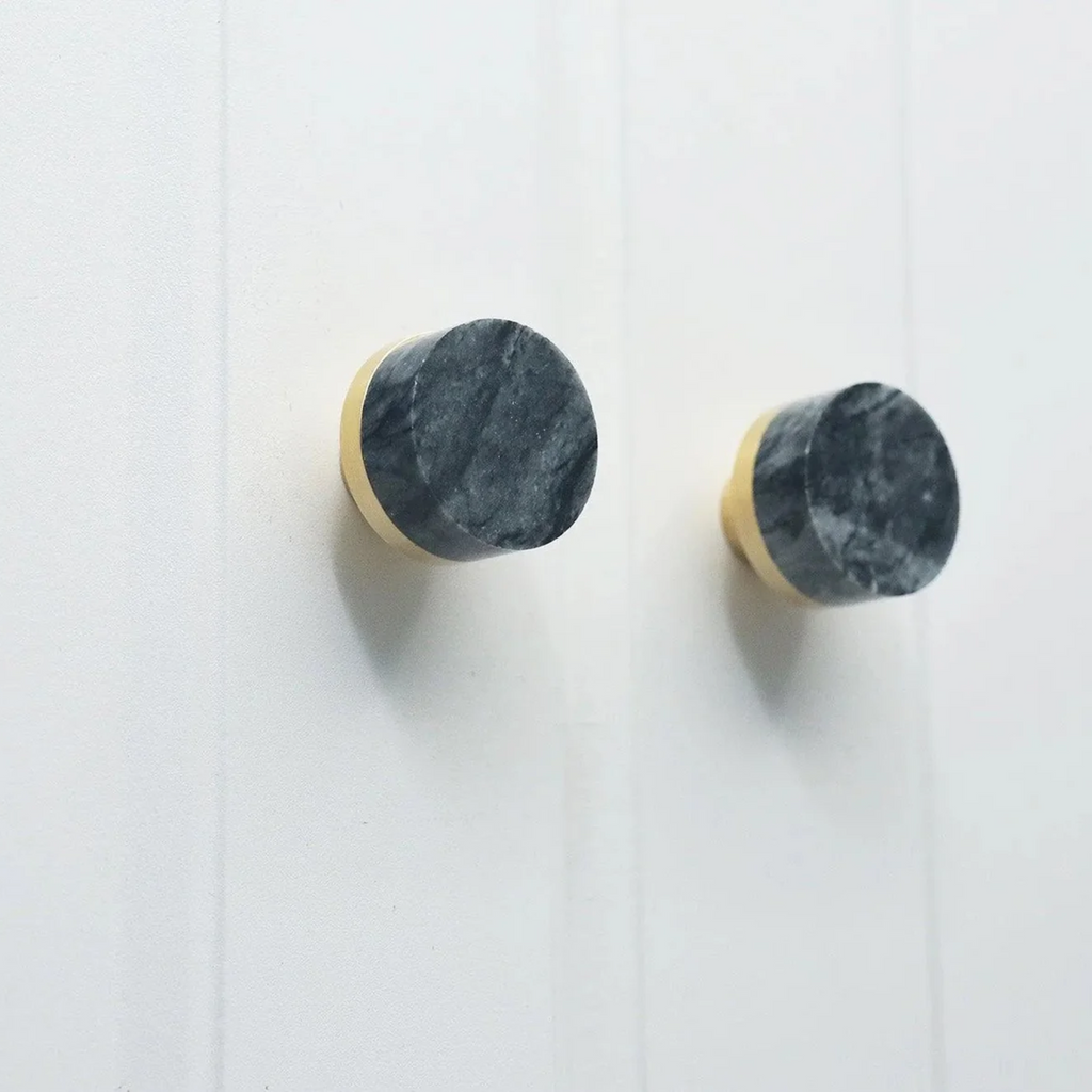 Brass Essence Karish marble and brass knobs with luxury finish, showcasing elegant round design and polished surface for cabinets.