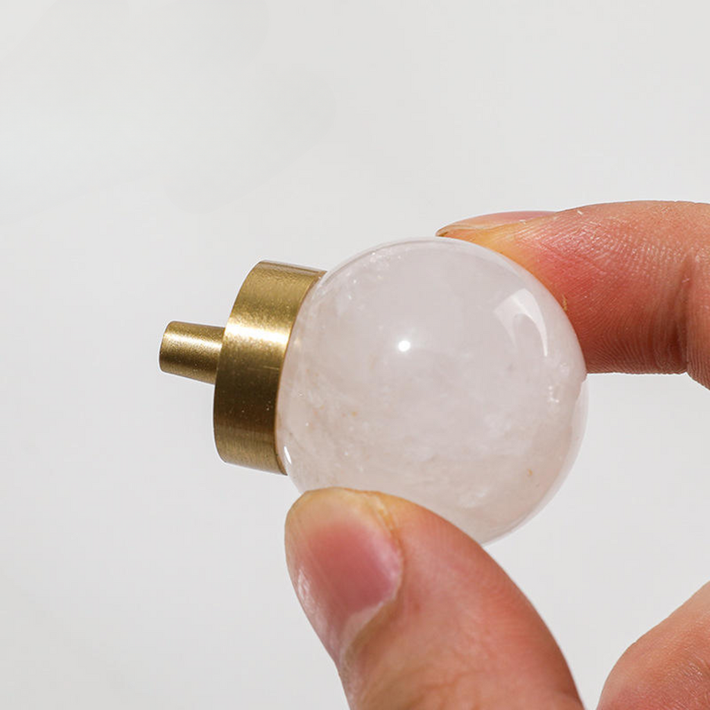 Natural crystal ball and brass cabinet knob from Brass Essence, showcasing the elegant glass sphere and polished brass finish.