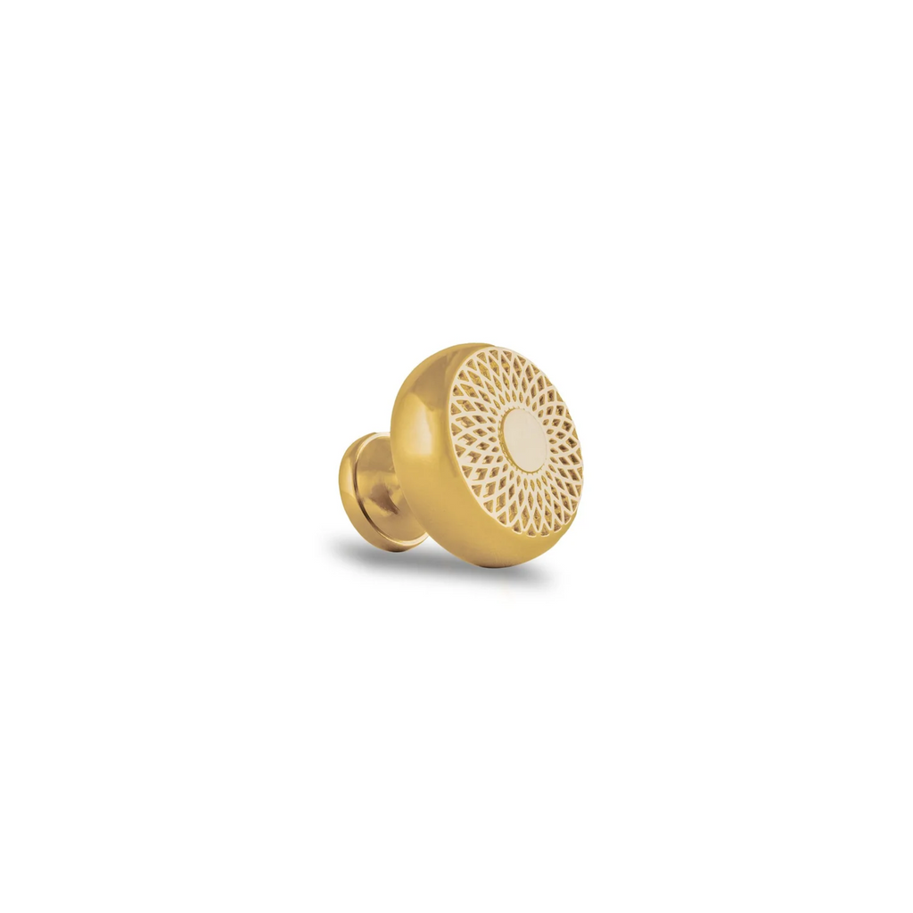 Brass Essence Mahi Amerock polished brass lattice knob with intricate lattice design, mounted on a wooden surface.