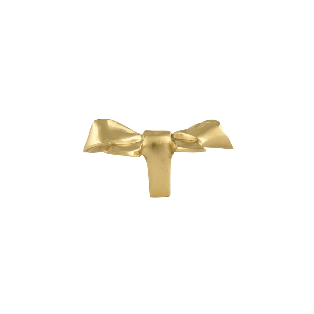 Polished brass bow cabinet knob from Brass Essence, featuring a sleek, shiny finish and elegant curved design.