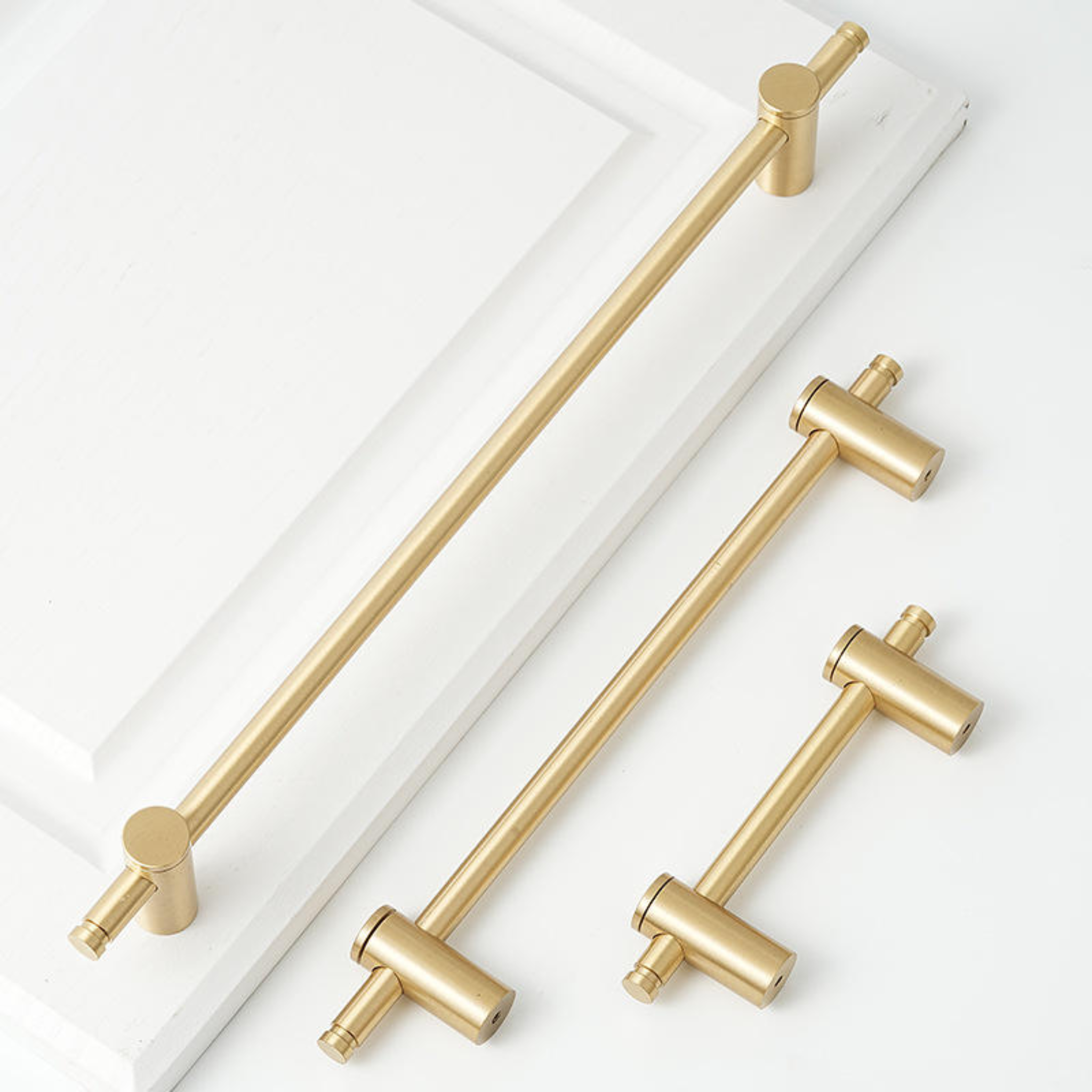 Adjustable solid brass bar handle from Brass Essence collection, featuring a sleek, polished finish on a modern hardware design.