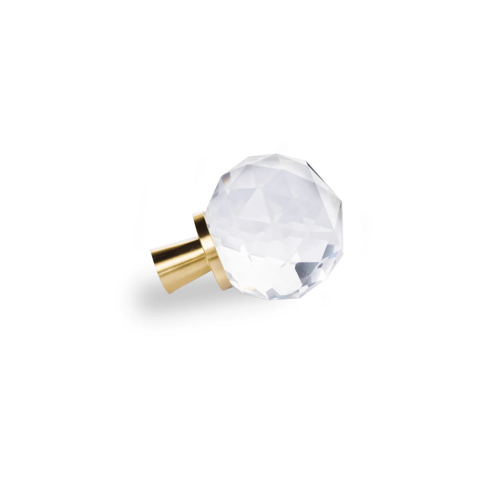 Faceted crystal and brass cabinet knob by Brass Essence, showcasing a sparkling crystal with polished brass finish.
