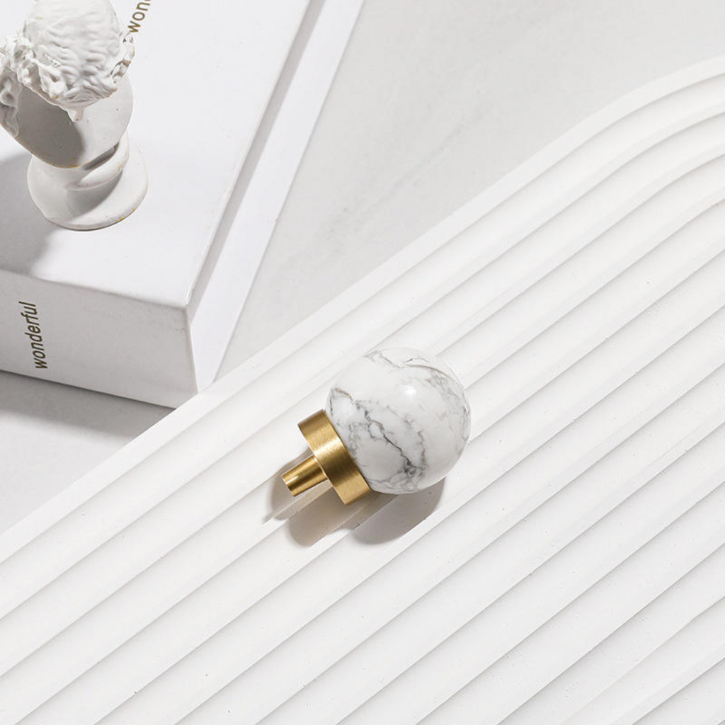 Brass Essence natural crystal ball and brass cabinet knob, showcasing the smooth crystal sphere and polished brass finish.