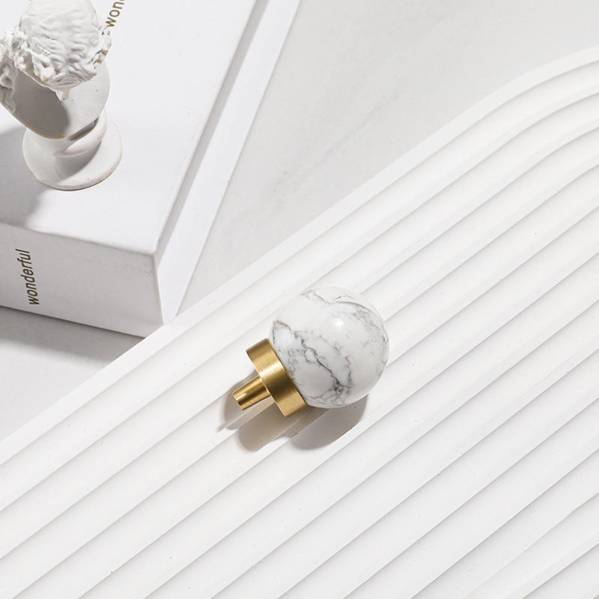 Brass Essence natural crystal ball and brass cabinet knob, showcasing the smooth crystal sphere and polished brass finish.