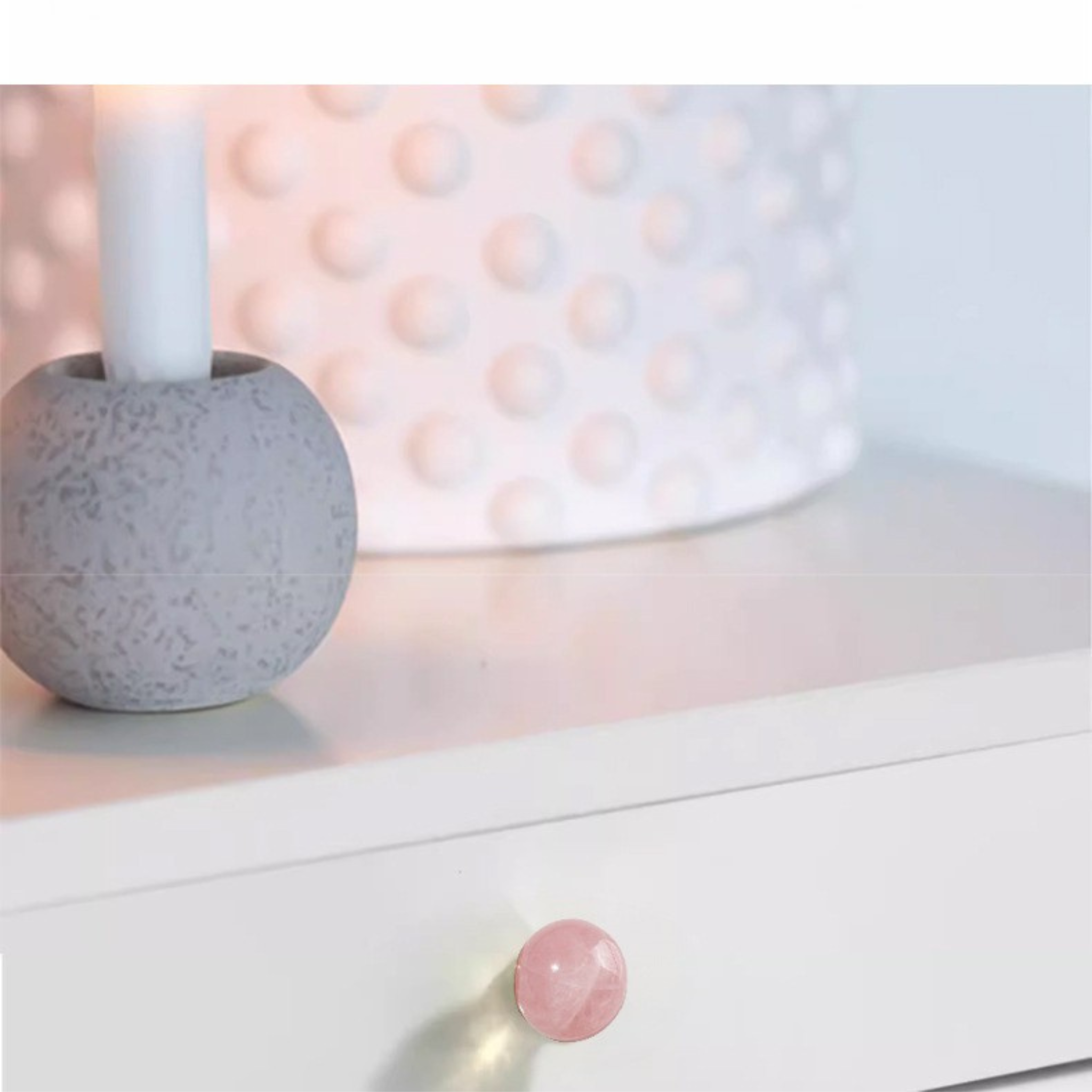 Brass essence natural crystal ball and brass cabinet knob, shiny round decorative hardware on a wooden surface.