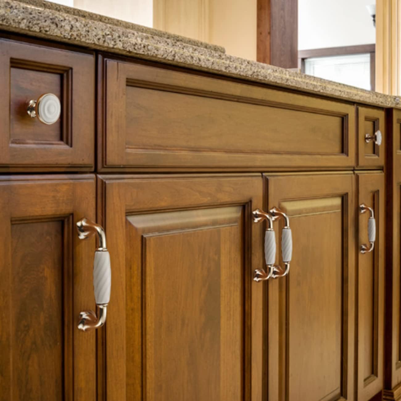 Brass essence ridged ceramic and zinc cabinet pull with sleek design, featuring textured ridges and polished metallic finish.