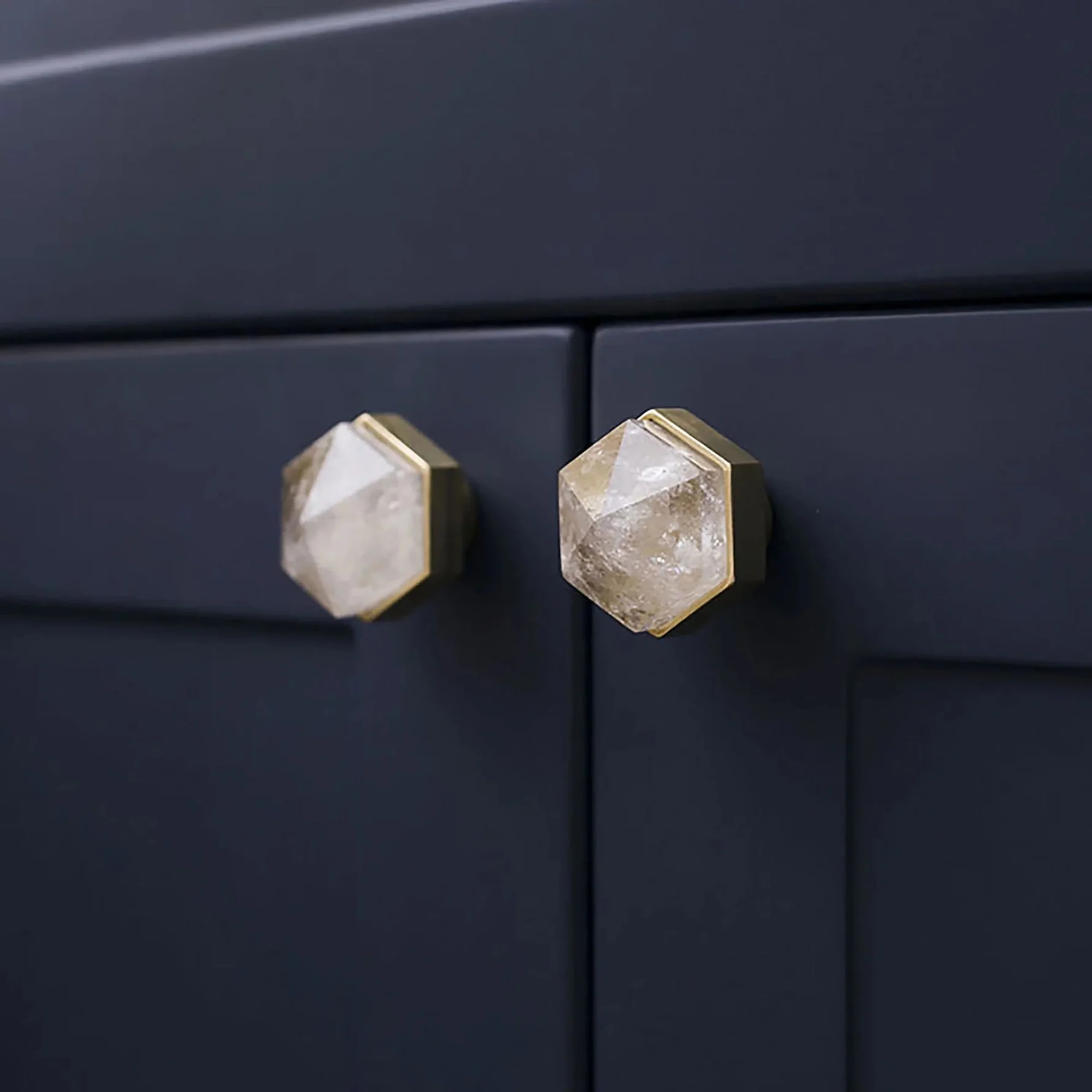 Brass Essence natural crystal and brass hexagon drawer knob, showcasing a polished crystal with brass hexagon base and decorative accents.