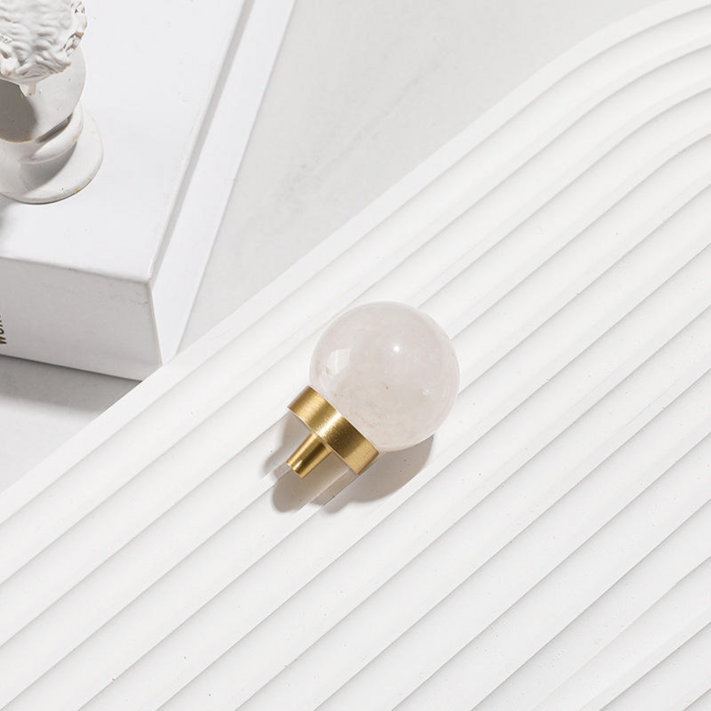 Brass Essence natural crystal ball and brass cabinet knob, decorative antique-style hardware featuring a clear glass ball and brass finish.