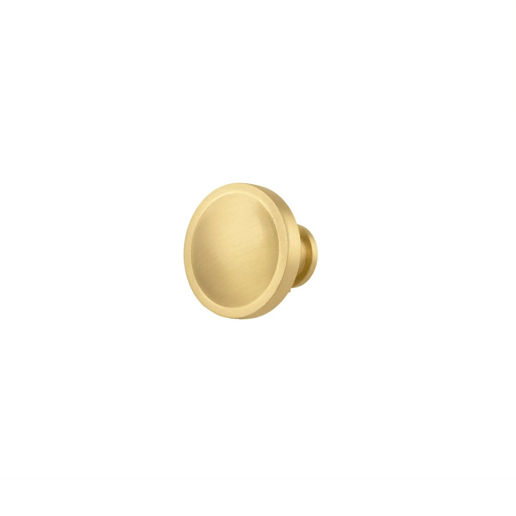 Brass essence Krisha brushed brass round knob with smooth finish, ideal for cabinet or drawer hardware.