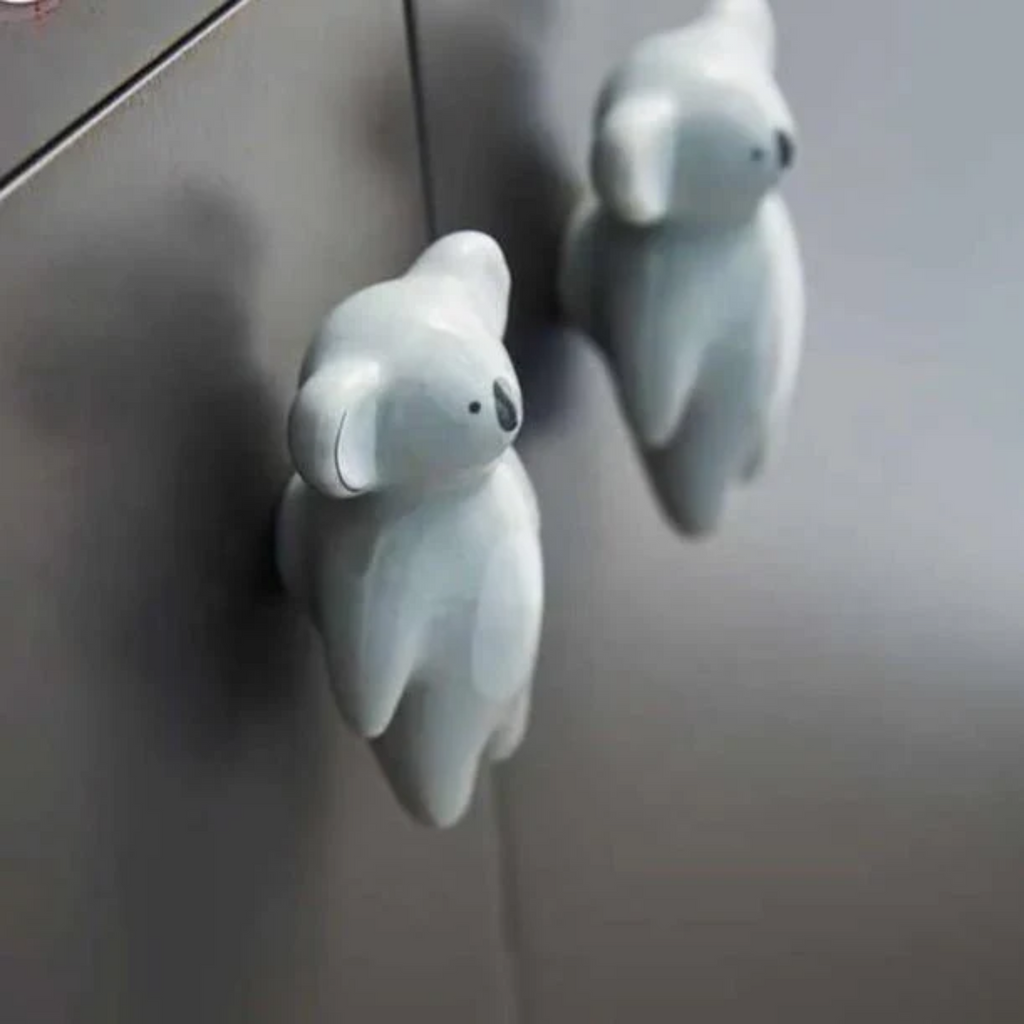Ceramic animal cabinet pull from Brass Essence collection featuring a detailed animal design on a white ceramic handle.