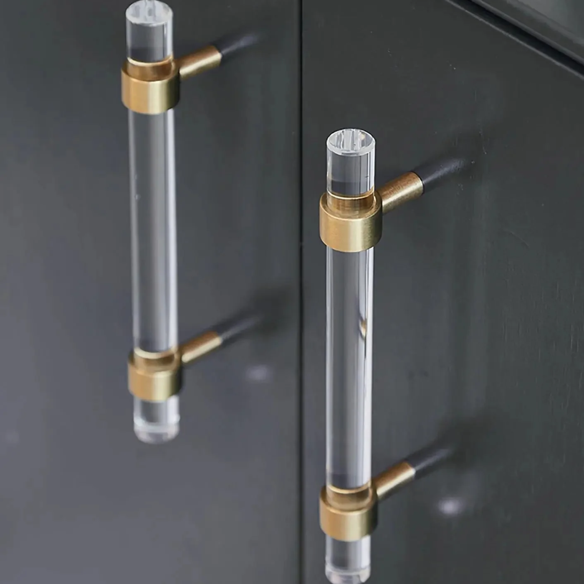 Brass Essence acrylic and brass T-bar handle collection with clear acrylic and polished brass finishes, displayed in a set.