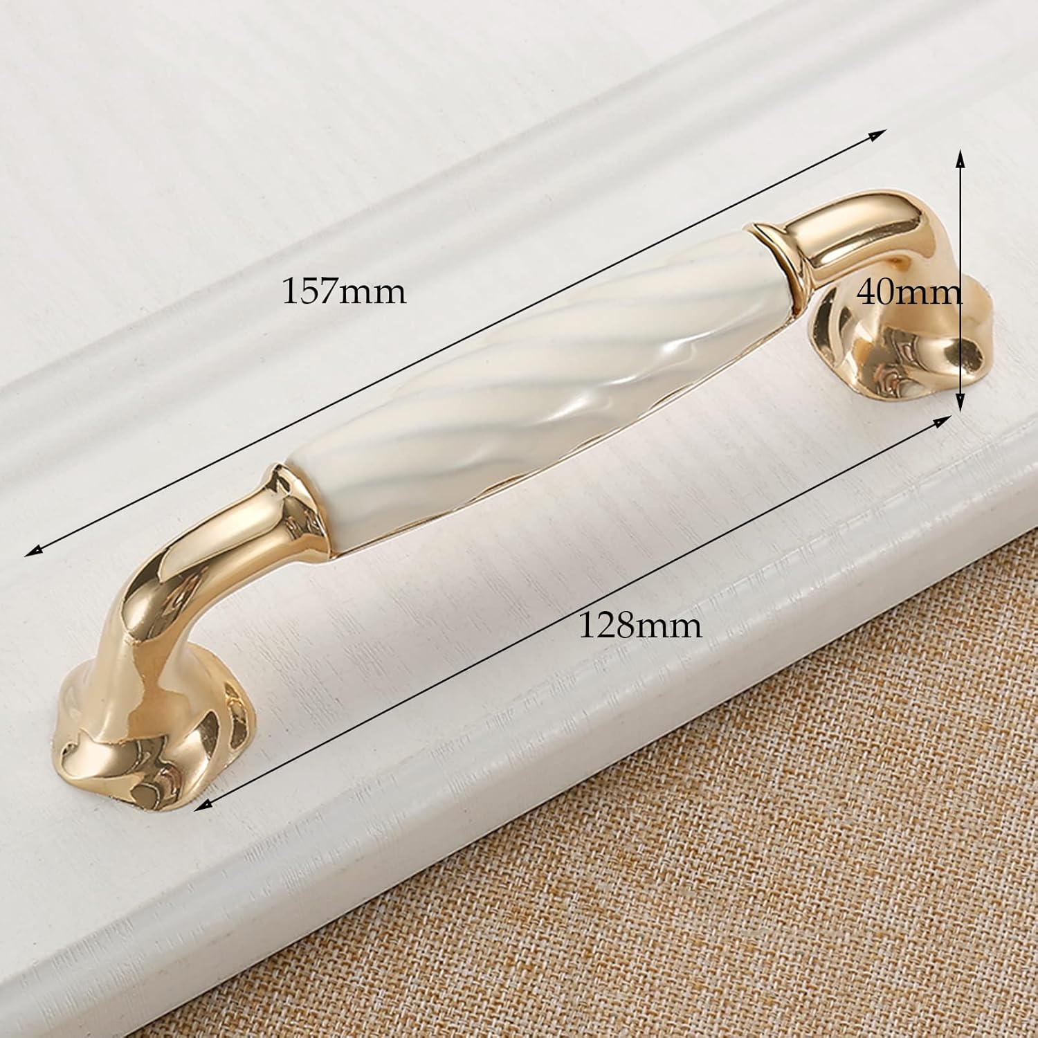 Brass Essence Ridged Ceramic and Zinc Cabinet Pull with textured design for kitchen or bathroom cabinetry.