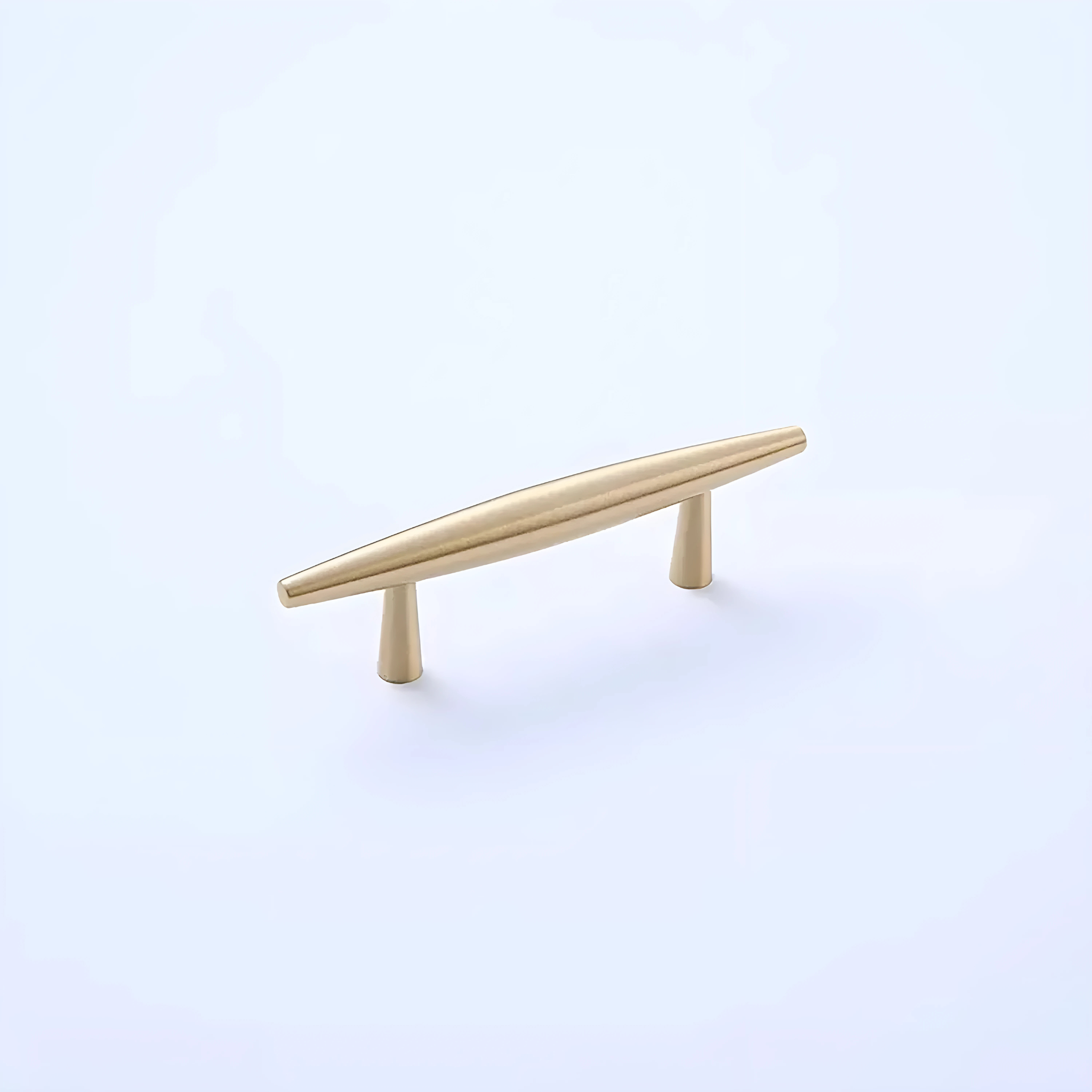 Brass Essence tapered brass spindle cabinet pull with rounded ends, mounted on a wood cabinet for a classic hardware look.