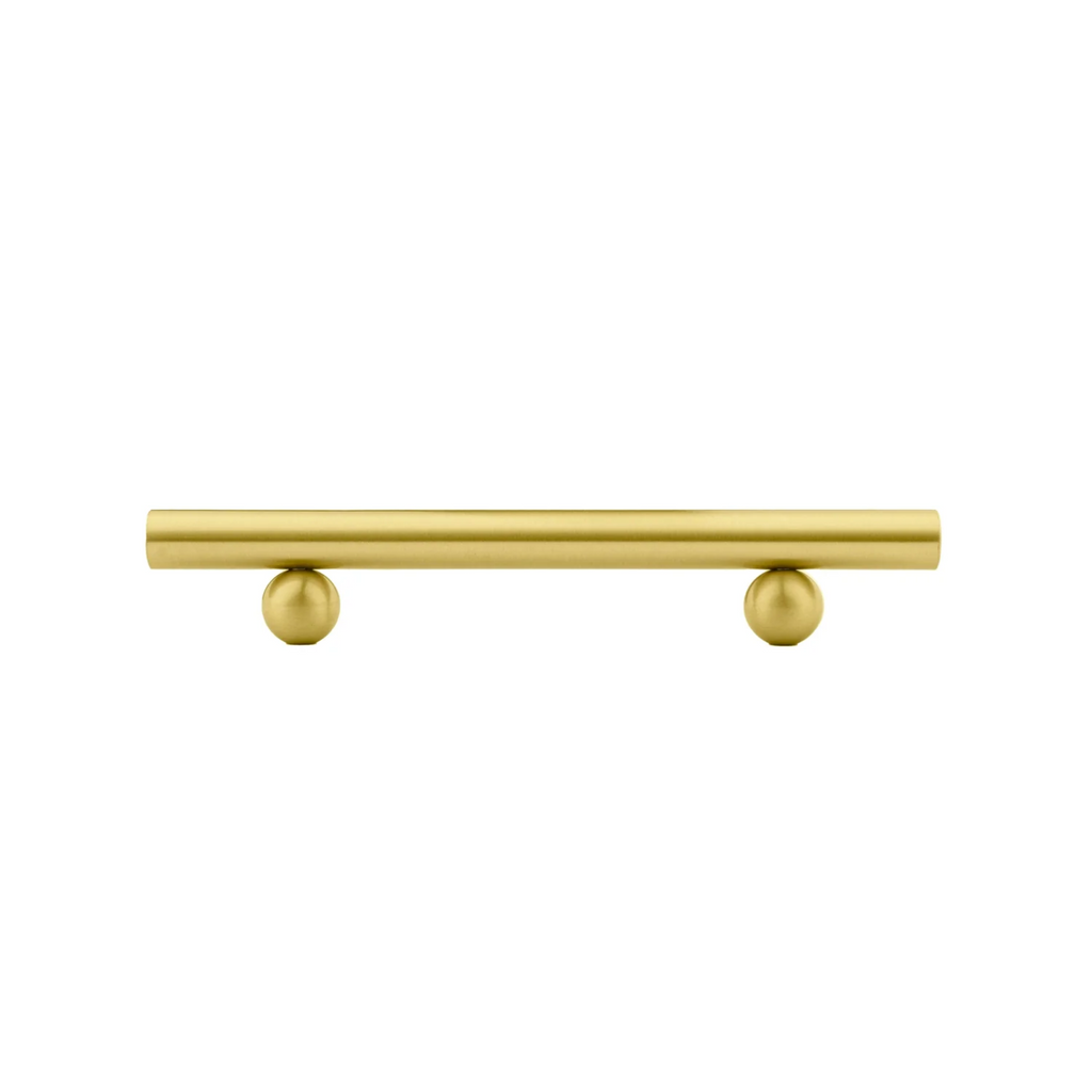 Solid brass goblet cabinet handle from Brass Essence collection with a polished finish, mounted on a cabinet surface.