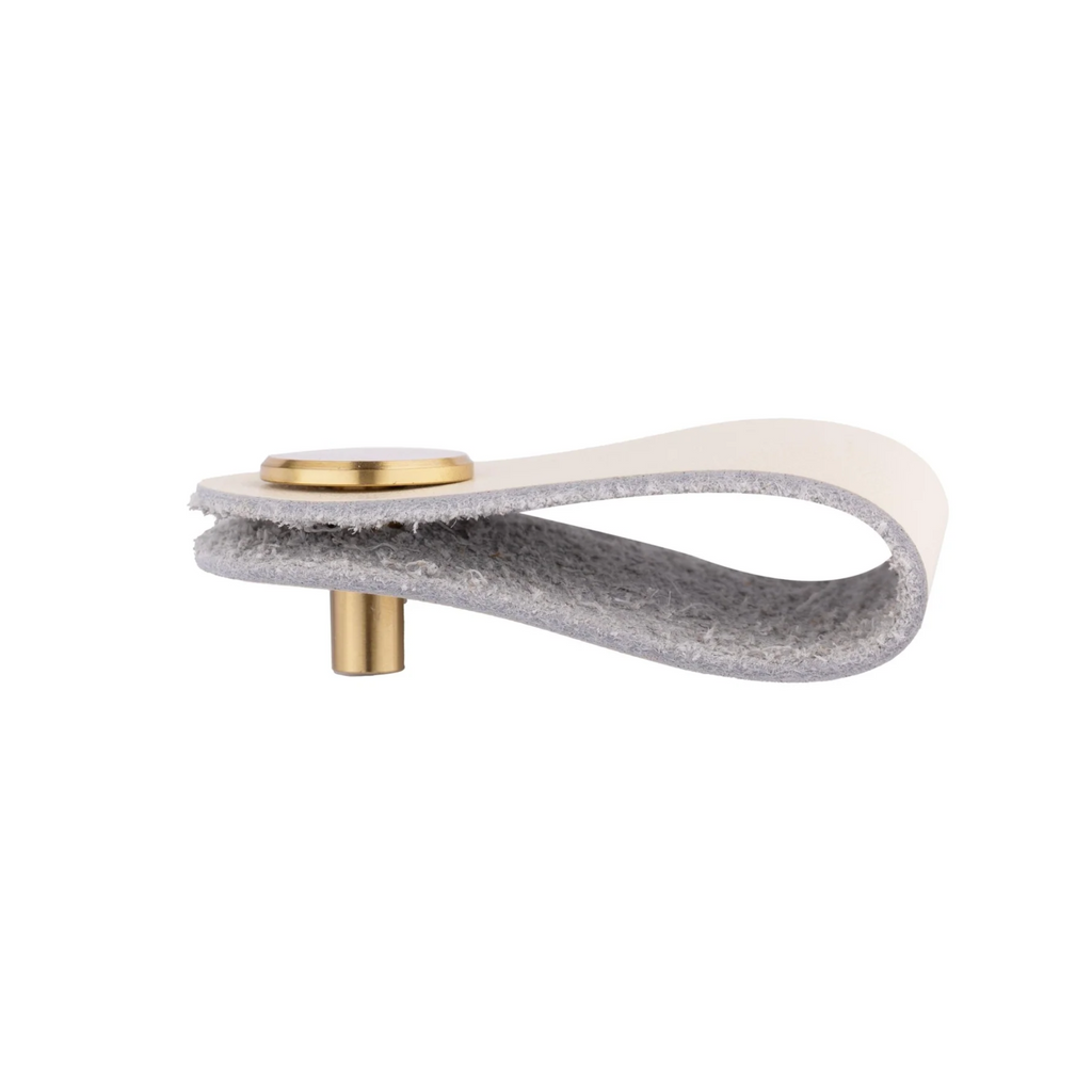Brass essence leather and brass strap cabinet pull featuring a sleek leather strap and polished brass hardware.