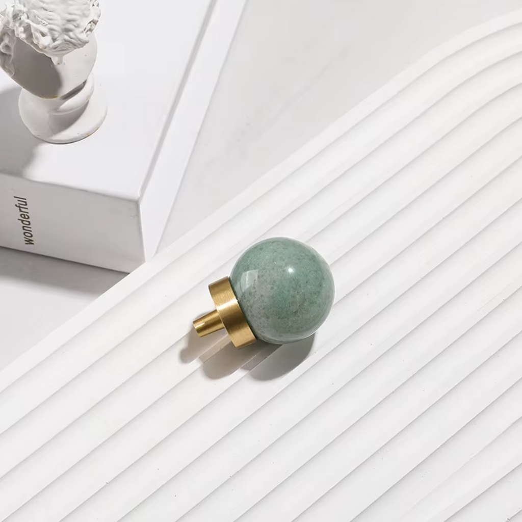 Natural crystal ball and brass cabinet knob by Brass Essence, showcasing a clear crystal sphere and elegant brass hardware.