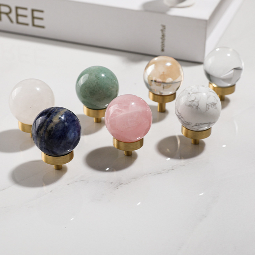 Brass essence natural crystal ball and brass cabinet knob, showcasing the clear crystal sphere and ornate metallic finish.