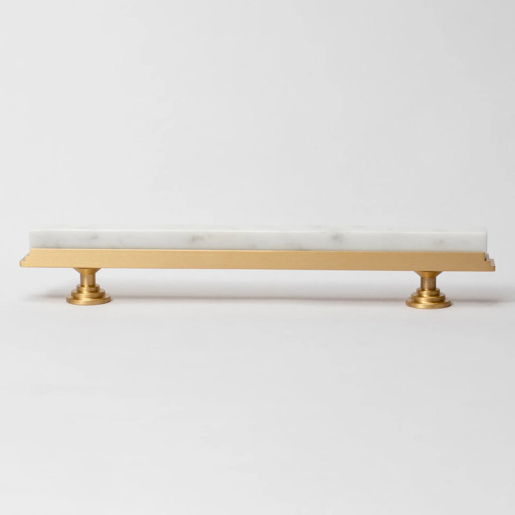 Karish Modern White Marble and Brass T-Bar Handle by Brass Essence, close-up view of elegant bathroom or furniture hardware