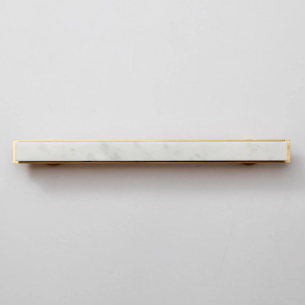 Modern white marble and brass T-bar handle by Brass Essence, featuring sleek design and polished finish.