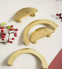 Pair of hammered brass half-circle drawer pulls by Brass Essence, featuring textured finish and vintage-inspired design.