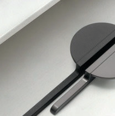 Brass Essence Hemi Cycle Zinc Half-Circle Pull handle with a shiny metallic finish, mounted on a surface for furniture or cabinetry.